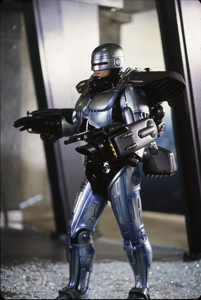 Robocop standing on the ground wearing a jet pack